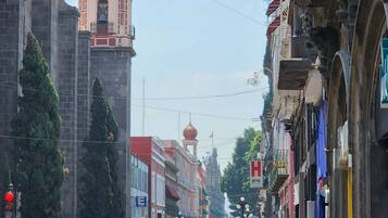 A street view with a prominent church tower and a sign for 'Posada Guadalupe'.