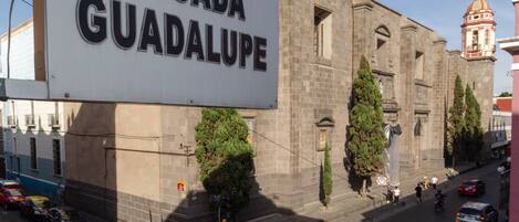 A street scene with a large sign reading "POSADA GUADALUPE".