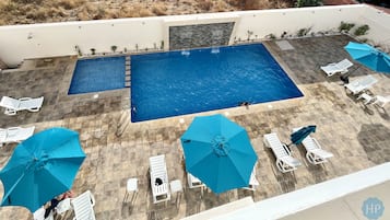 Outdoor pool, open 10:30 AM to 8:00 PM, pool umbrellas