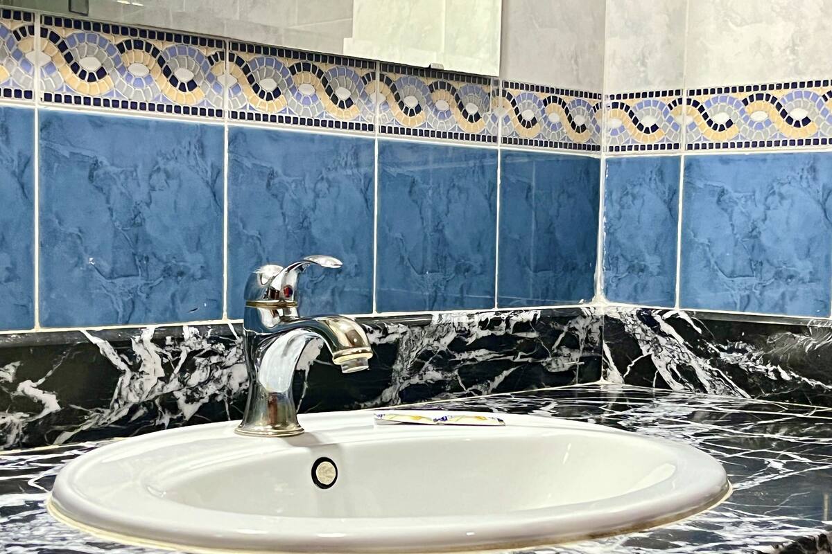 deep-soaking bathtub, rainfall showerhead, free toiletries, bathrobes