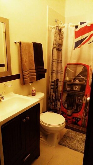 A bathroom with a toilet, sink, and a towel rack. - Apartamento Real Ibiza 639 by Sinbad (Playa del Carmen)