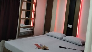 A single bed with a white mattress and pillows, a red curtain, and a ceiling with recessed lighting. - Hotel Sogo Roxas Blvd (Pasay)