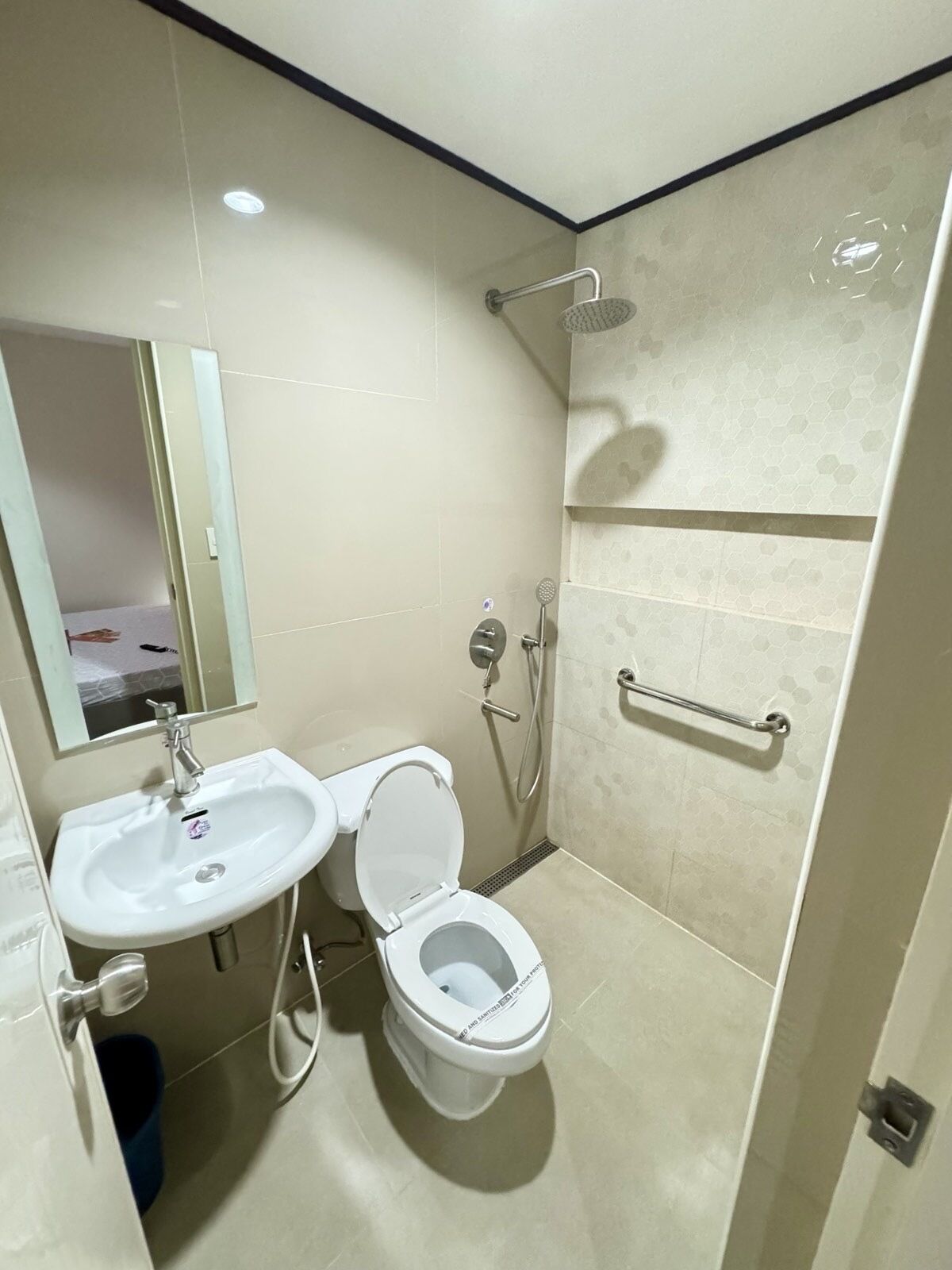 A modern bathroom with a sink, toilet, and shower.