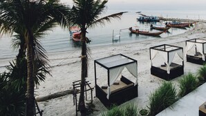 A beachside resort with overwater bungalows, a sandy beach, and boats in the water. - The Beach Samui (Koh Samui)