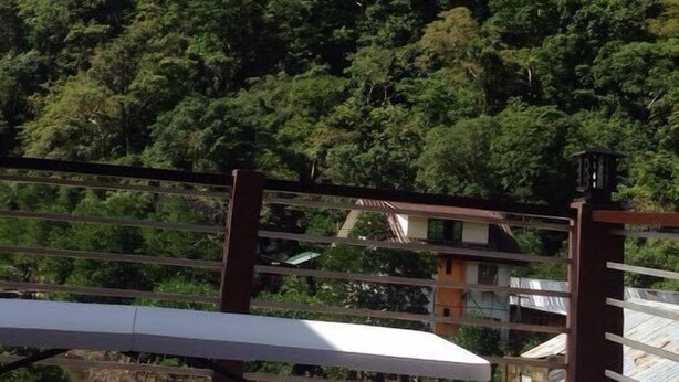 A terrace with tables and chairs, overlooking a mountainous landscape with dense greenery. - Lolo Bob's Bed And Breakfast (El Nido)