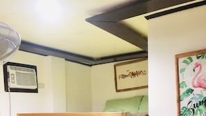 A bunk bed with a wooden frame and floral-patterned bedding. - Lolo Bob's Bed And Breakfast (El Nido)