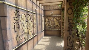 A corridor with ancient Egyptian hieroglyphs on the walls and ceiling. - Golden Amoon Resort (Hoskote)