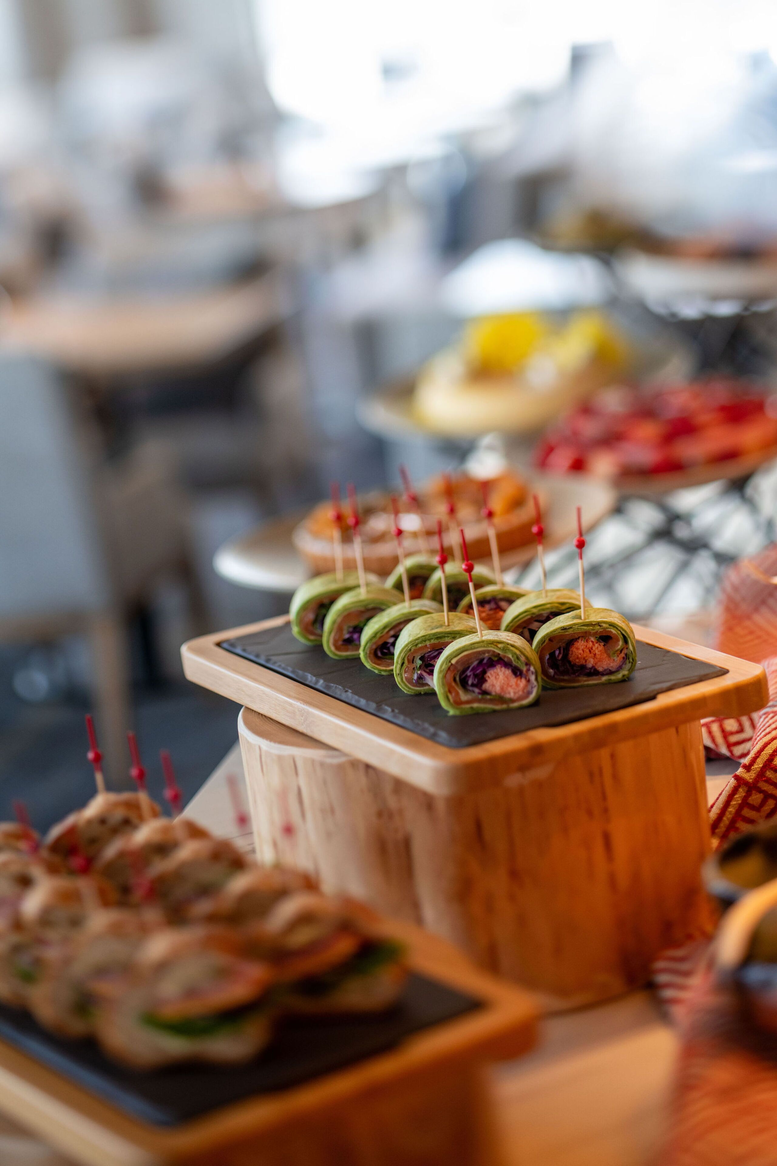 A buffet with various food items, including sushi rolls and other appetizers.