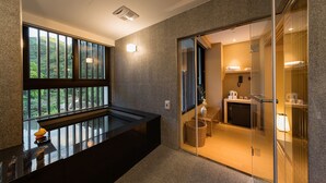 A modern bathroom with a glass shower enclosure, a sink, and a toilet. - Asia Pacific Hotel Beitou (Taipei)
