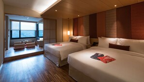 A hotel room with two beds, a sitting area with a view, and a large window. - Asia Pacific Hotel Beitou (Taipei)