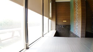 A modern bathroom with large windows, a shower area, and a tiled wall. - Lan Yang Resort Four Seasons (Dongshan)