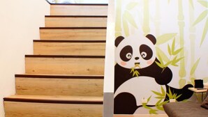 A wooden staircase with a panda-themed wall mural. - Lan Yang Resort Four Seasons (Dongshan)
