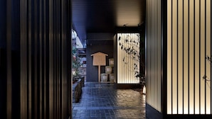 A narrow pathway leading to a traditional Japanese entrance with a wooden signboard and bamboo decorations. - Hotel Resol Kyoto Kawaramachi Sanjo (Kyoto)