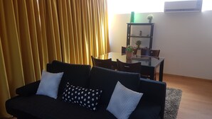 Panoramic Studio, Multiple Beds | Living area | Flat-screen TV