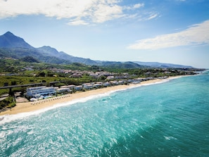 A coastal town with a beach, houses, and mountains in the background. - Hotel Poseidon (Belvedere Marittimo)