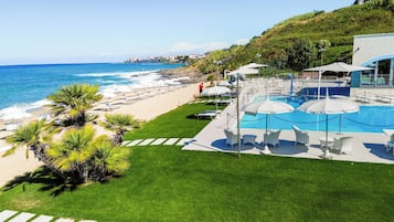 A resort with a pool, beach, and ocean view.