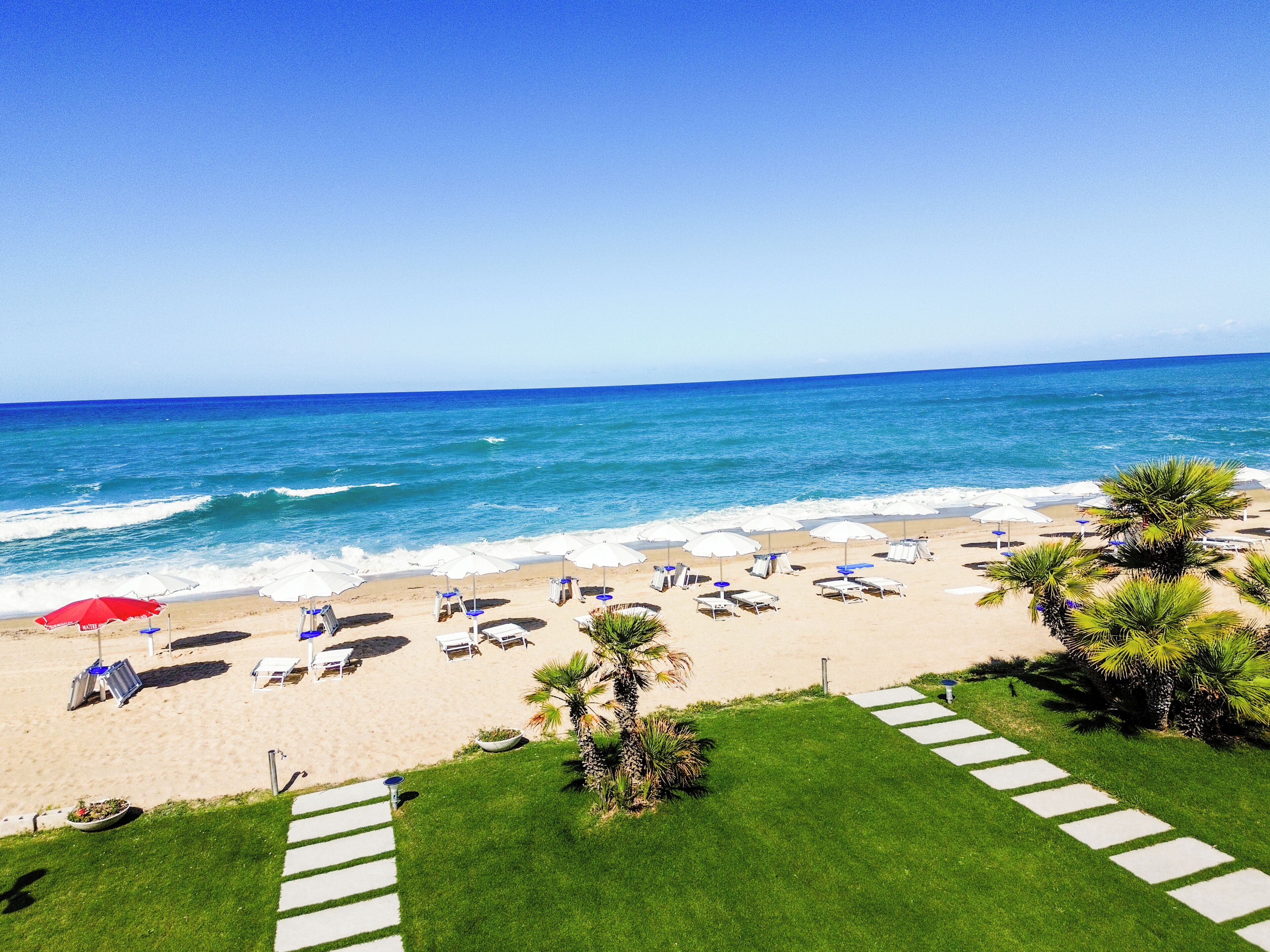 Private beach, white sand, sun loungers, beach umbrellas