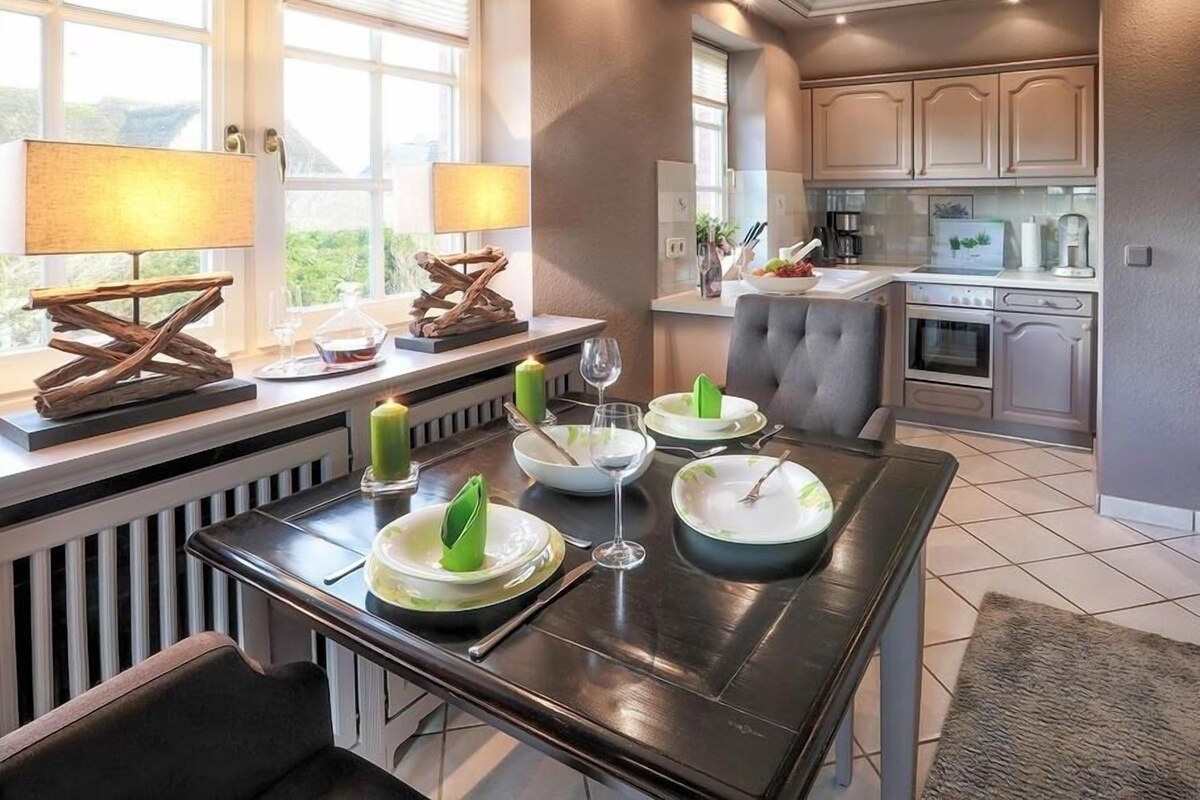 A modern kitchen with a dining area.