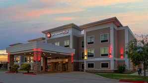 A hotel with a modern design, featuring a covered entrance, multiple floors, and a sign indicating it is part of the Best Western Plus chain. - Best Western Plus Bay City Inn & Suites (Bay City)