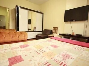 A bedroom with a bed, a dresser, a chair, a television, and a mirror. - GoHouse Copacabana 1203 (Rio de Janeiro)