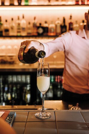 A bartender pouring a drink into a glass. - Mantra Albury Hotel (Albury)