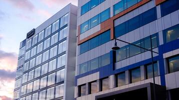 A modern building with a glass facade and a sign that reads "Maya."