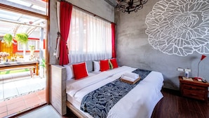A bedroom with a large bed, red and white bedding, a chandelier, and a wall mural. - Farmland B&B (Sanxing)