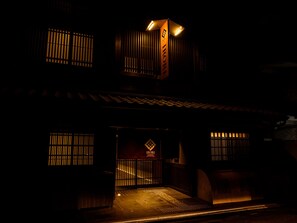 A traditional building with a dark facade, illuminated entrance, and signage indicating a restaurant. - Irori Kyoto Station Higashi-honganji (Kyoto)