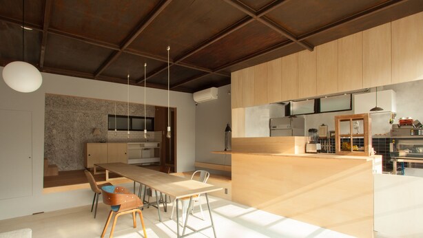 A modern kitchen with a central island, wooden cabinets, and pendant lighting. - Sumidanagaya - Hostel (Tokyo)