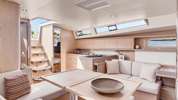 A modern RV interior with a kitchen, dining area, and a cozy seating space. - Discover Sailing Asia - Hong Kong (Sai Kung)
