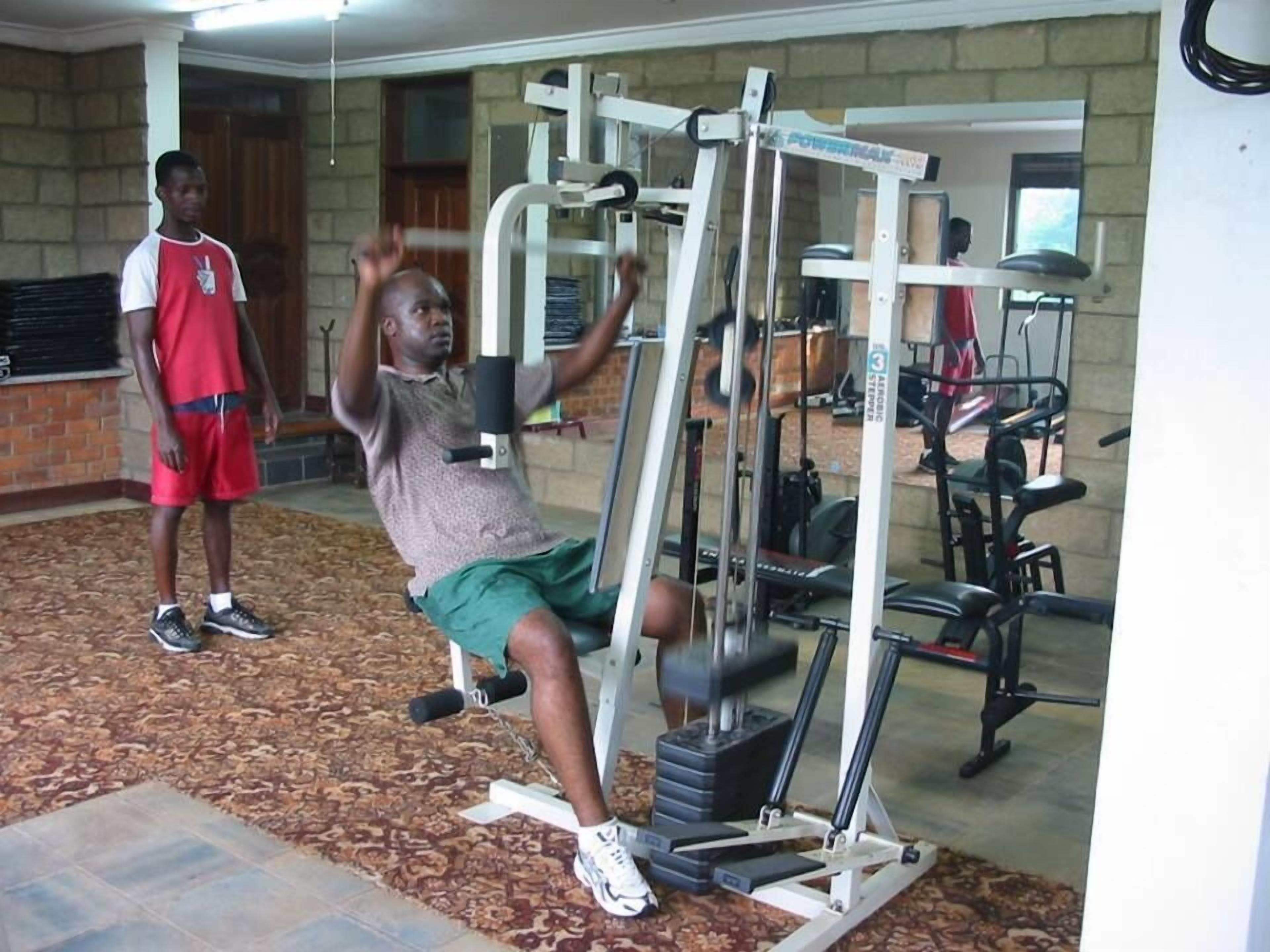 A gym with various exercise equipment, including a pull-up bar and weight machines.
