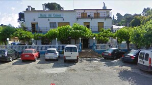 A building labeled "Hostal del Gurmen" with a parking area in front. - Hostal del Carmen (Terrassa)