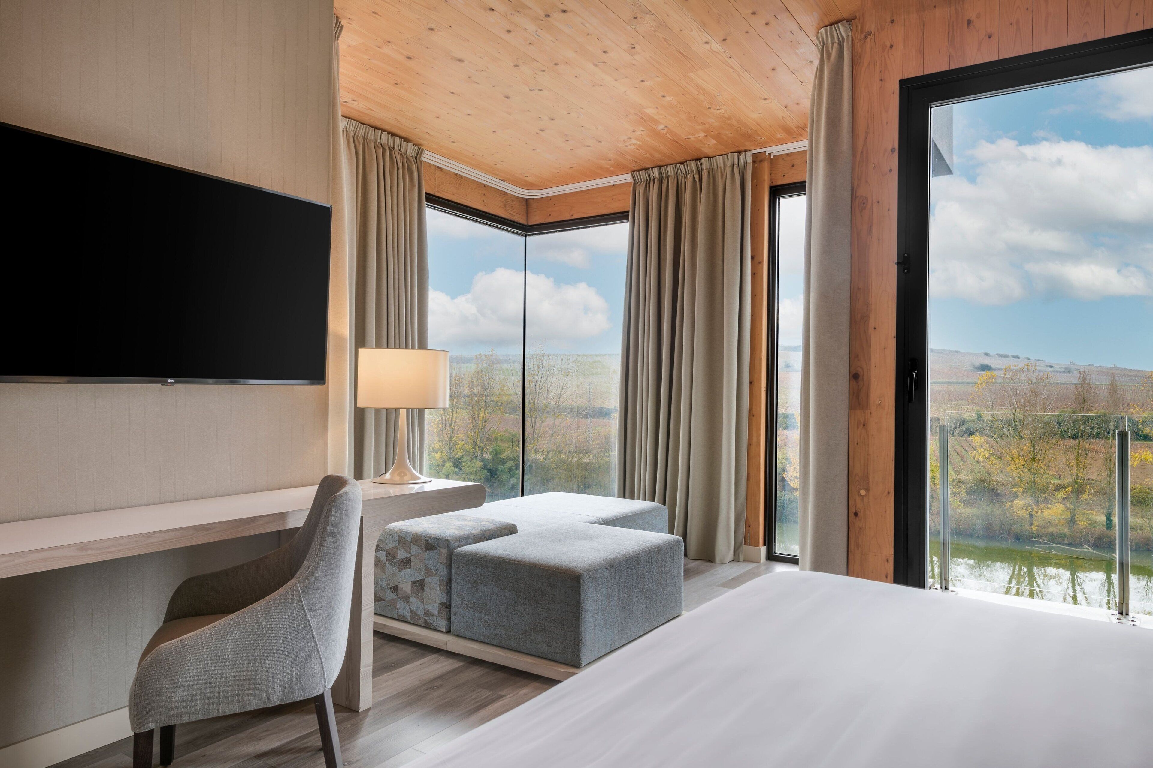 junior suite, 1 king bed, river view | 1 bedroom, minibar, in-room safe, desk