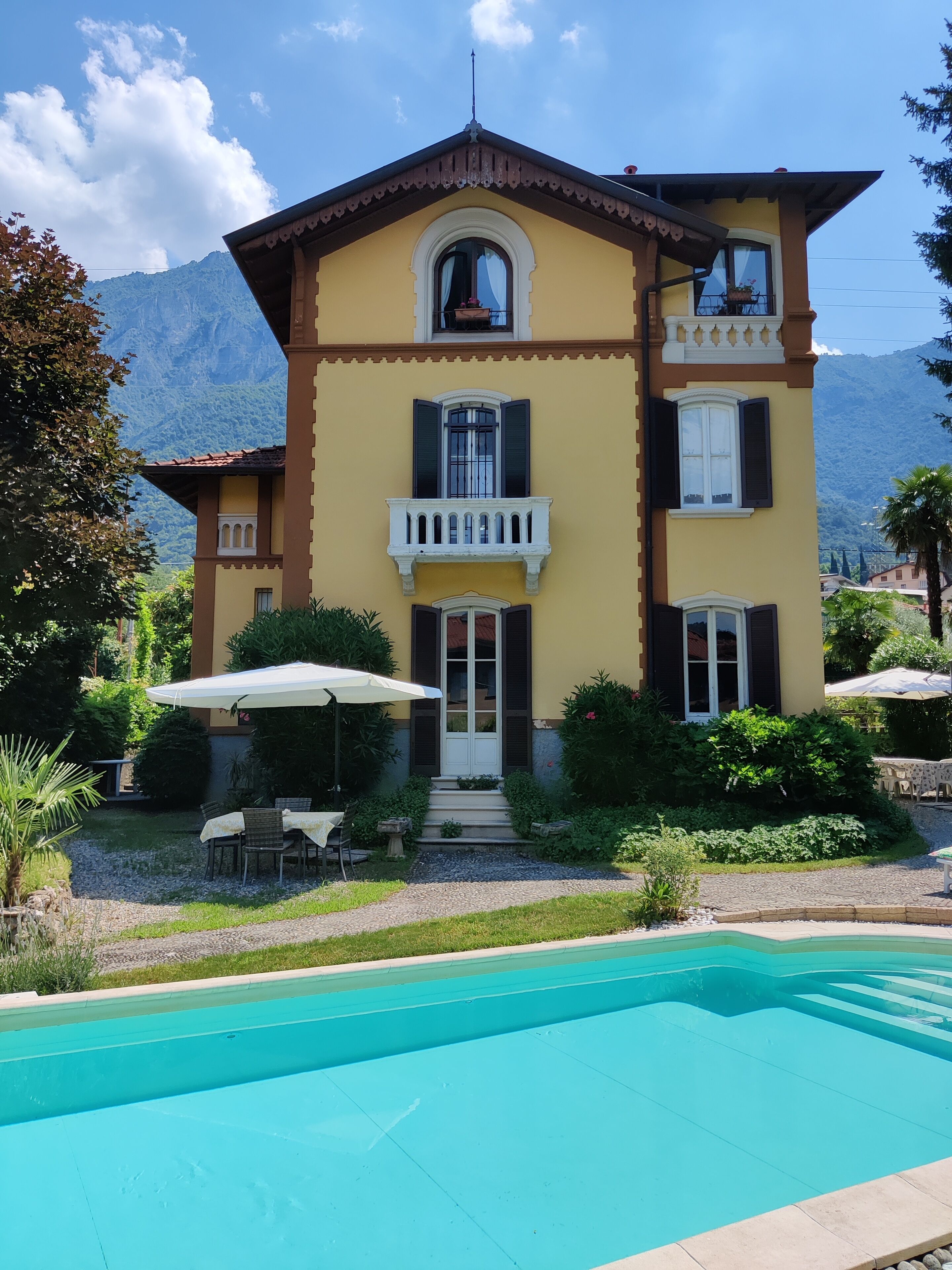 A two-story building with a swimming pool in front.
