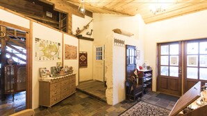 A wooden interior with a staircase, a wooden cabinet, and a door with a window. - Raven's Bed and Breakfast (Reykjanesbær)