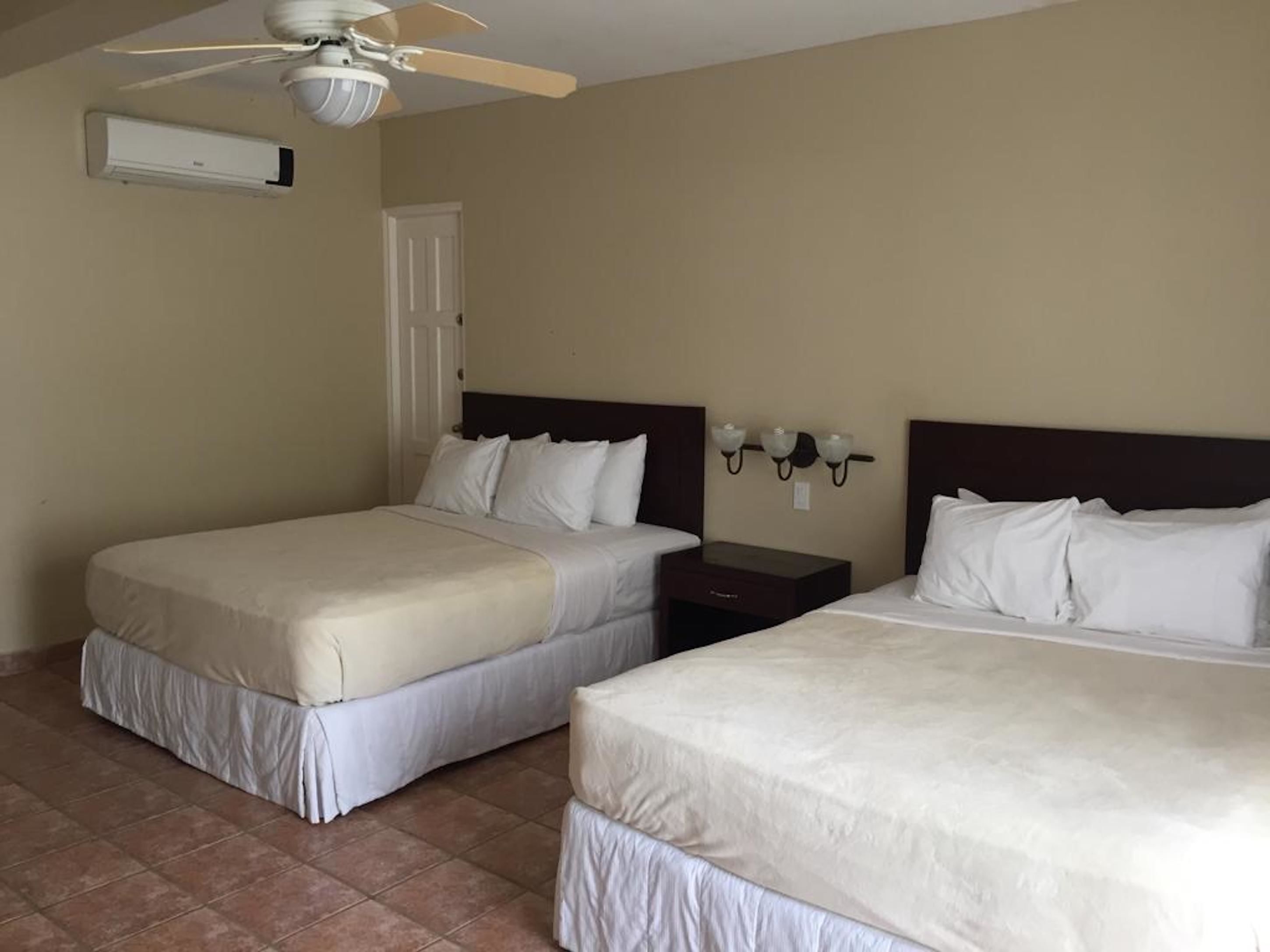 deluxe room, 2 queen beds | in-room safe, iron/ironing board, free cots/infant beds, bed sheets