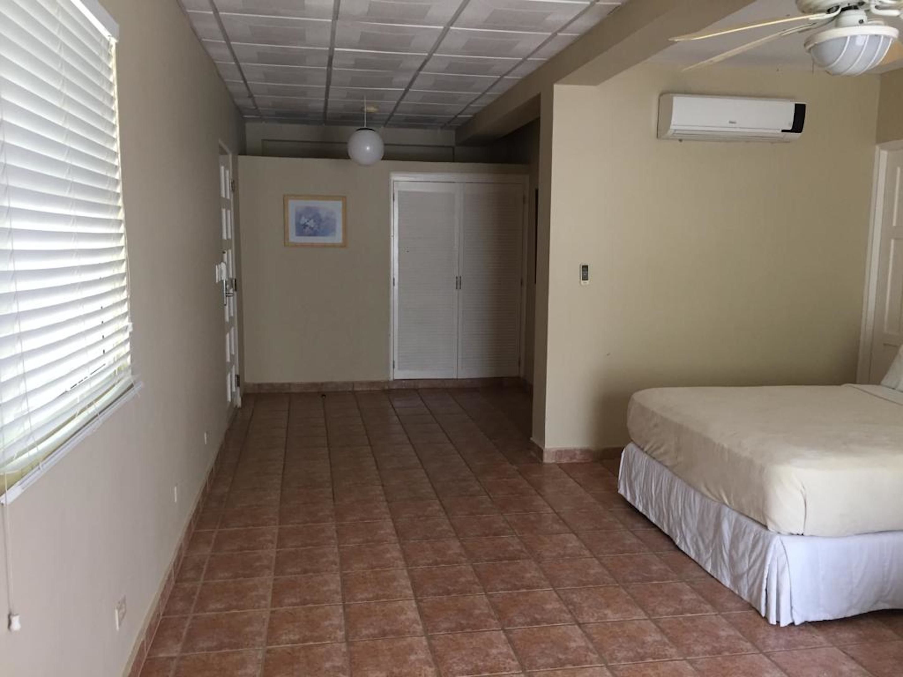 deluxe room, 2 queen beds | in-room safe, iron/ironing board, free cots/infant beds, bed sheets