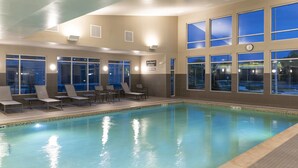 An indoor swimming pool with lounge chairs and a clock on the wall. - Residence Inn by Marriott Lafayette (Lafayette)