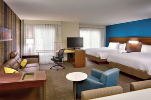 A hotel room with a bed, a desk, a chair, a small table, and a TV. - Residence Inn by Marriott Salt Lake City-West Jordan (West Jordan)