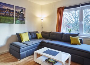 Apartment, 1 Bedroom | Living area | 42-inch flat-screen TV with cable channels, TV, DVD player - Apartments Goslar (Goslar)