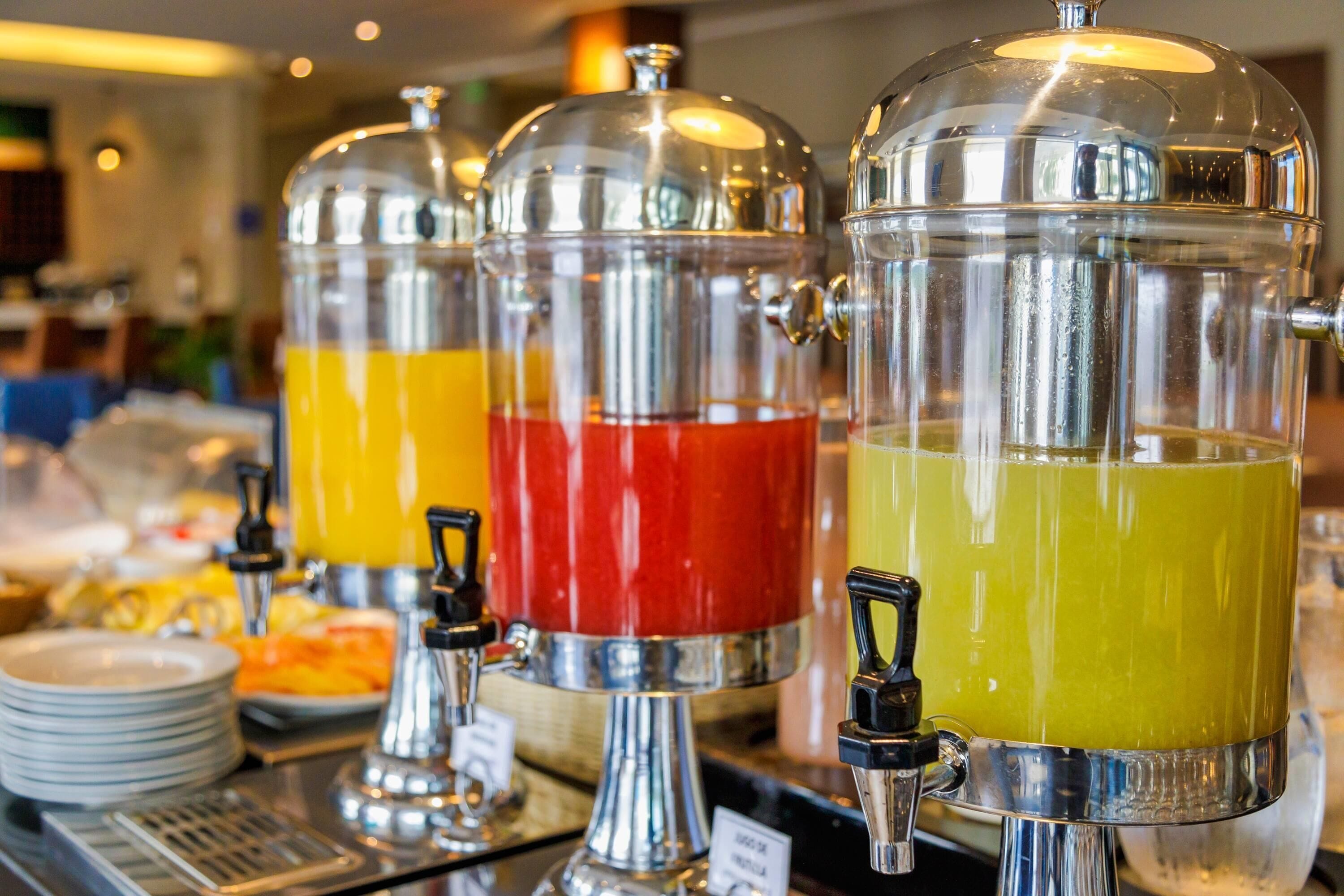 A beverage dispenser with multiple colorful drinks.
