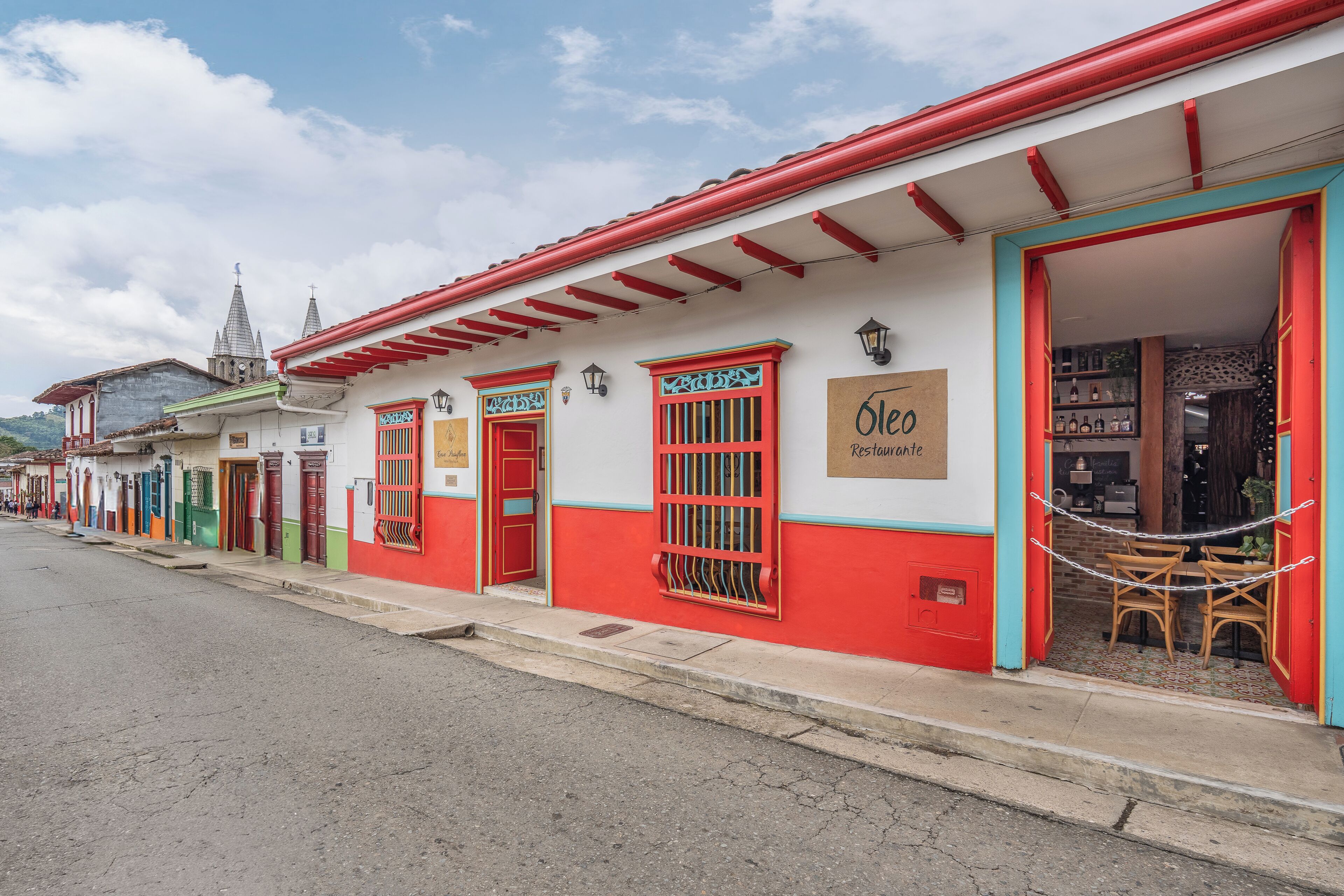 A row of colorful buildings with a restaurant named 'Ole Restaurante' on the right.