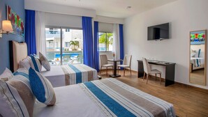 A hotel room with two beds, a desk, a chair, a TV, and a balcony with a pool.
