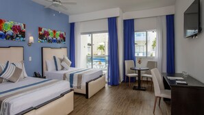 A hotel room with two beds, a desk, a chair, a small table, and a balcony with a view. - whala!urban punta cana (Punta Cana)