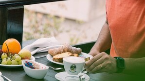 A person seated at a table with a meal, a cup, and a watch. - Hotel Belvedere (Sperlonga)