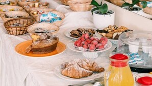 A breakfast buffet with various food items and baskets. - Hotel Belvedere (Sperlonga)
