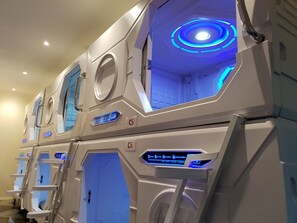 A row of modern, well-lit massage chairs with digital displays and control panels. - Abbotsford Private Rooms & Pods @ 15 Charles Homestay (Abbotsford)