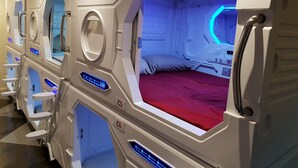 A row of hexagonal massage rooms with individual beds and control panels. - Abbotsford Private Rooms & Pods @ 15 Charles Homestay (Abbotsford)