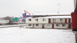 A motel with a 'Next Exit' sign, a 'Budget Inn' sign, and a 'City Center' sign. - Budget Inn (Caldwell)