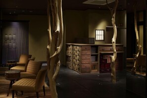 A room with a wooden cabinet, a chair, and a small table. - Taiza Onsen Sumihei (Kyotango)